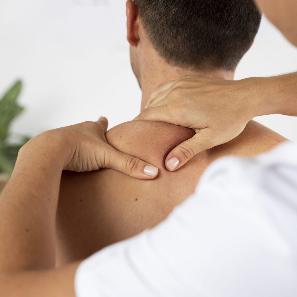 physiotherapist-performing-therapeutic-massage-male-client